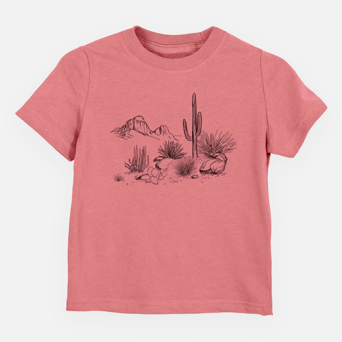 Mauve pink toddler t-shirt laid flat, printed with a black ink desert scene with a saguaro cactus, agave, rocks and distant mountains.