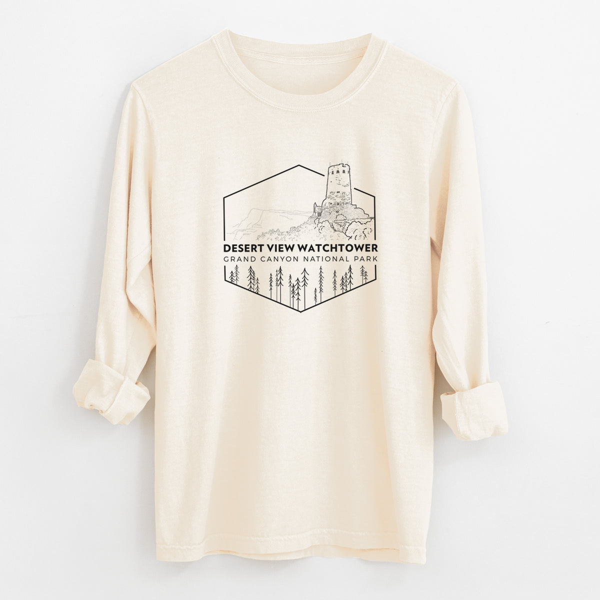 Ivory Comfort Colors long sleeve shirt laid flat with the cuffs rolled, printed with a black line art badge of the Desert View Watchtower above pine trees, with the words Desert View Watchtower, Grand Canyon National Park.
