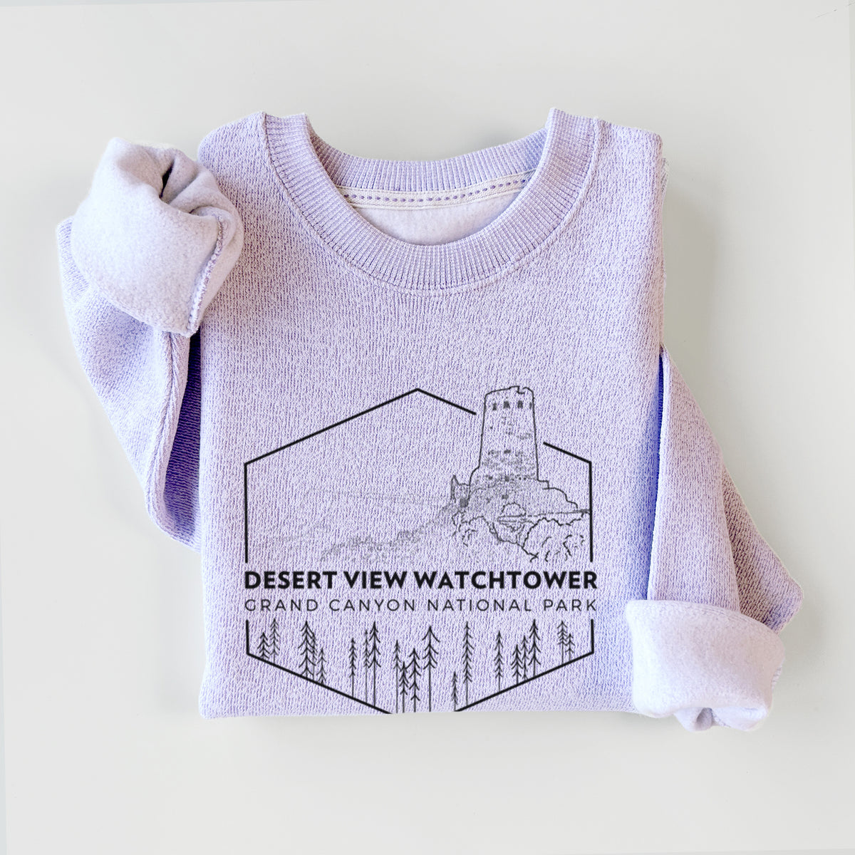 Ice purple knit sweatshirt printed with a black line art badge of the Desert View Watchtower above pine trees, with the words Desert View Watchtower, Grand Canyon National Park, styled flat.