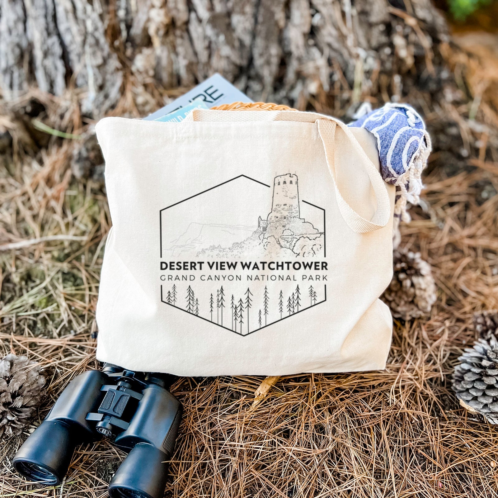 Natural canvas tote bag printed with a black line art badge of the Desert View Watchtower above pine trees, with the words Desert View Watchtower, Grand Canyon National Park.