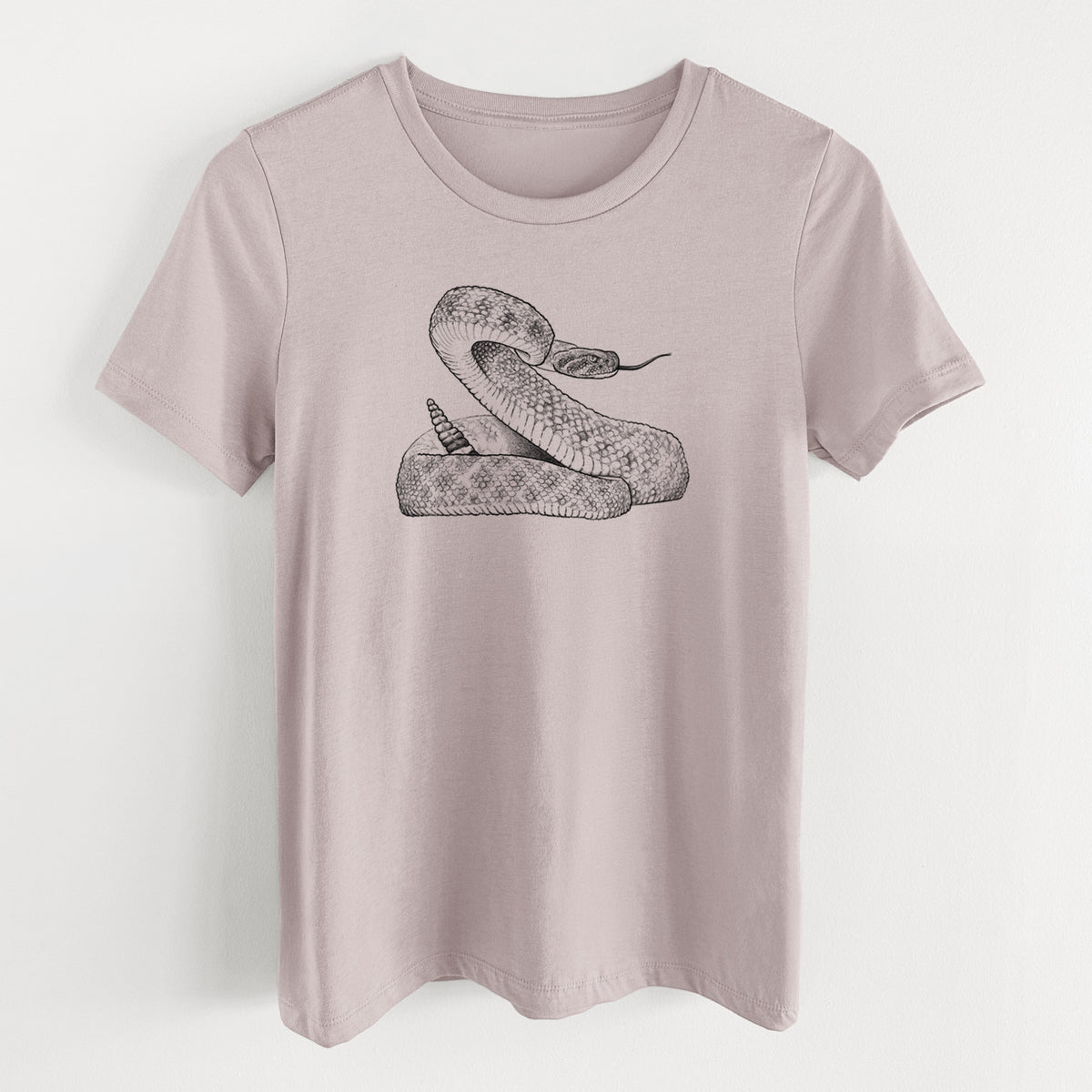 Pink gravel women's relaxed fit cotton t-shirt laid flat, printed with a detailed black ink illustration of a coiled diamondback rattlesnake.