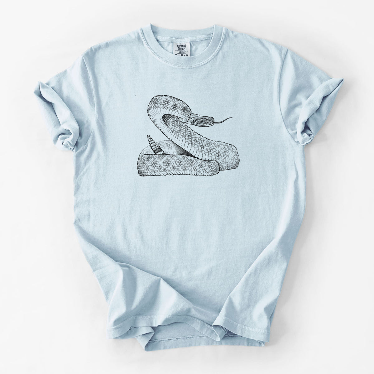 Chambray blue Comfort Colors t-shirt laid flat, printed with a detailed black ink illustration of a coiled diamondback rattlesnake.