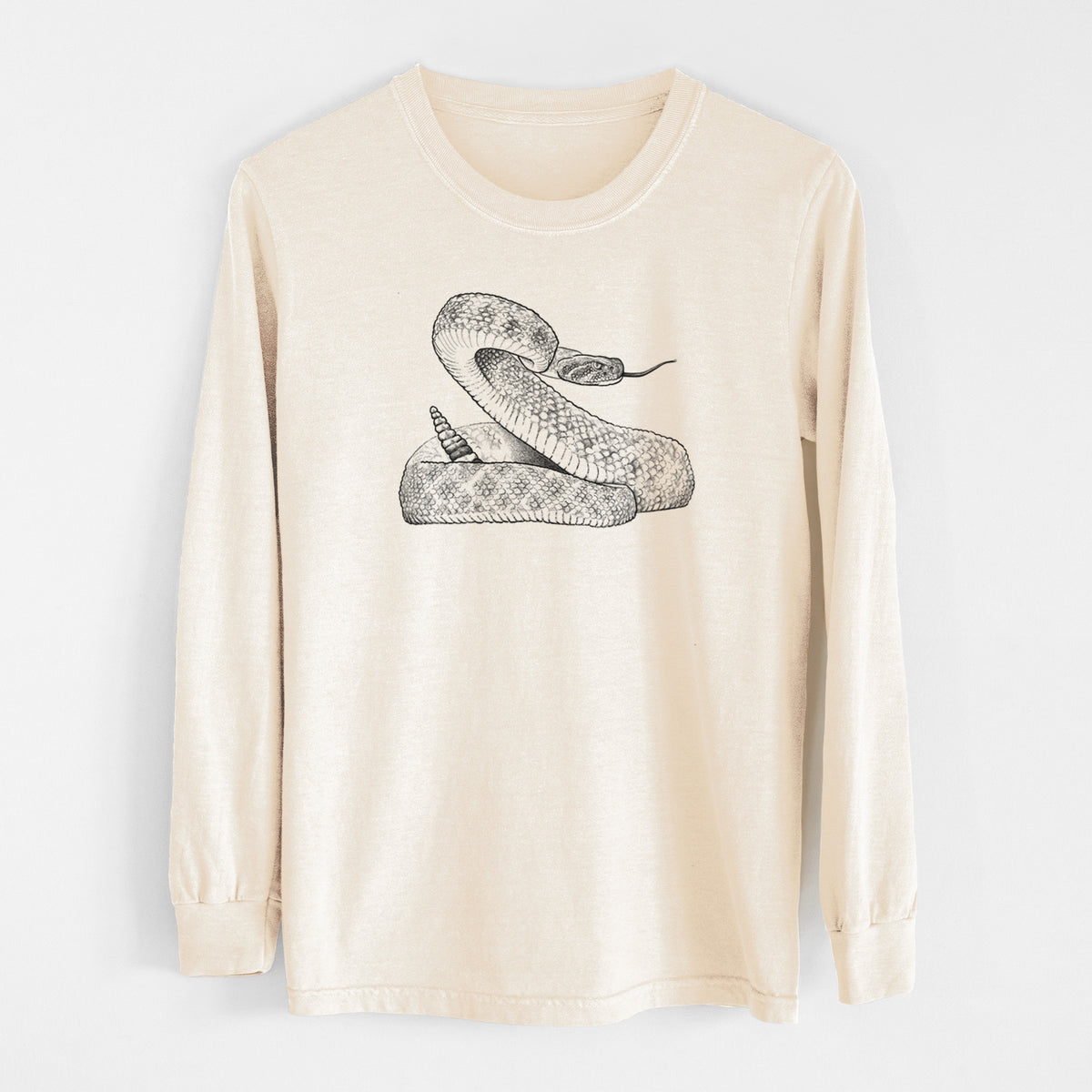 Ivory Comfort Colors long sleeve shirt laid flat, printed with a detailed black ink illustration of a coiled diamondback rattlesnake.