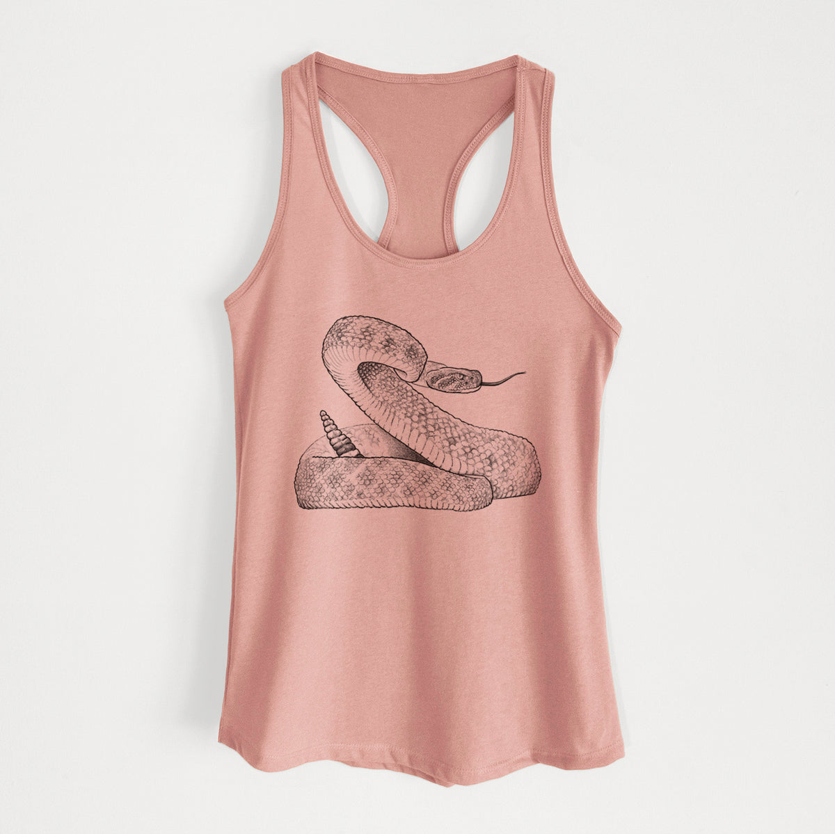 Desert pink women's racerback tank top laid flat, printed with a detailed black ink illustration of a coiled diamondback rattlesnake.