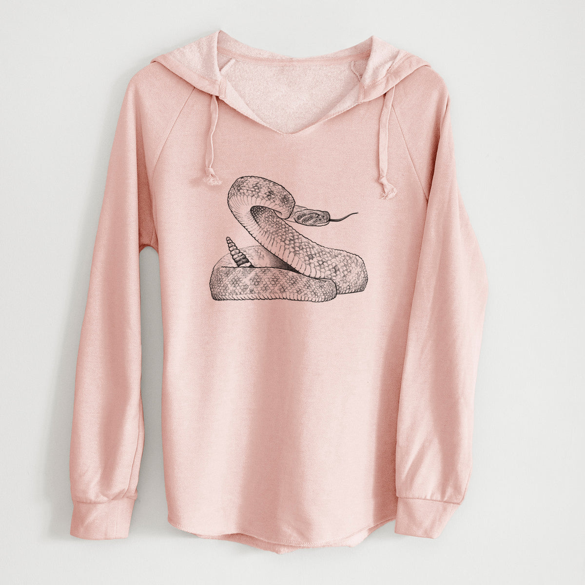 Blush pink women's Cali Wave hooded sweatshirt laid flat, printed with a detailed black ink illustration of a coiled diamondback rattlesnake.
