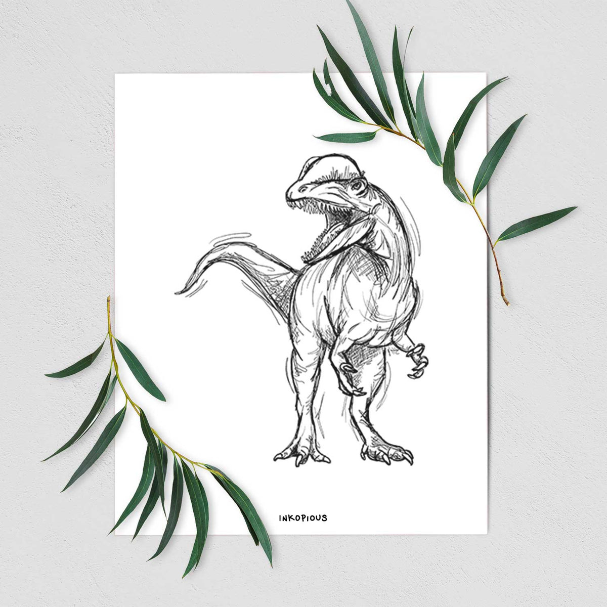 Art print of a black ink illustration of a Dilophosaurus with its neck frill, walking, shown with eucalyptus leaves.