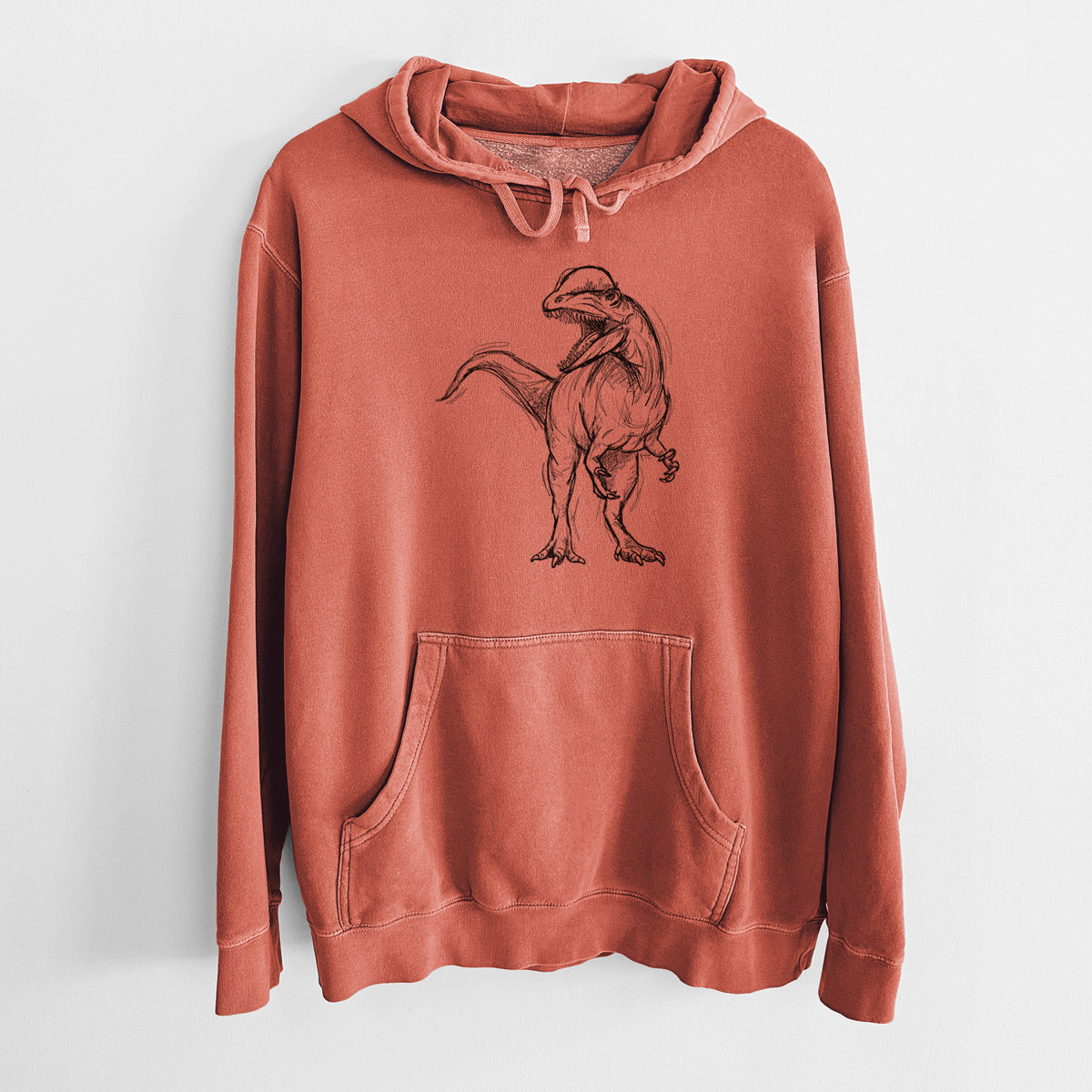 Amber orange pigment dyed hoodie laid flat, printed with a black ink illustration of a Dilophosaurus with its neck frill, walking.