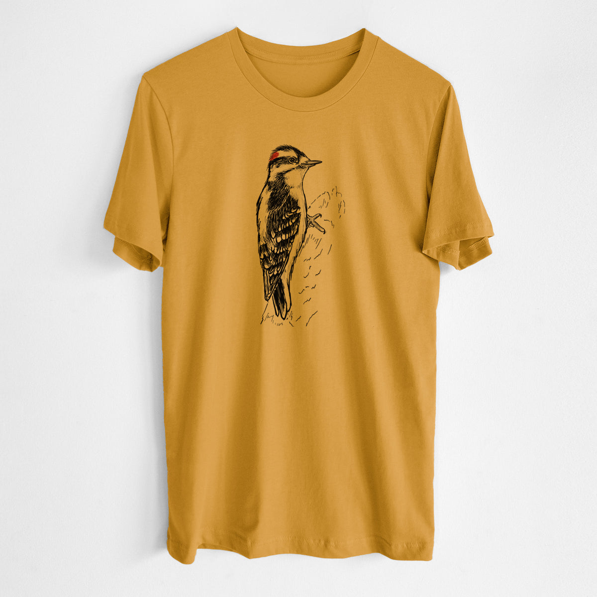 Honeycomb yellow lightweight cotton t-shirt laid flat, printed with a detailed black ink illustration of a downy woodpecker clinging to a tree trunk.