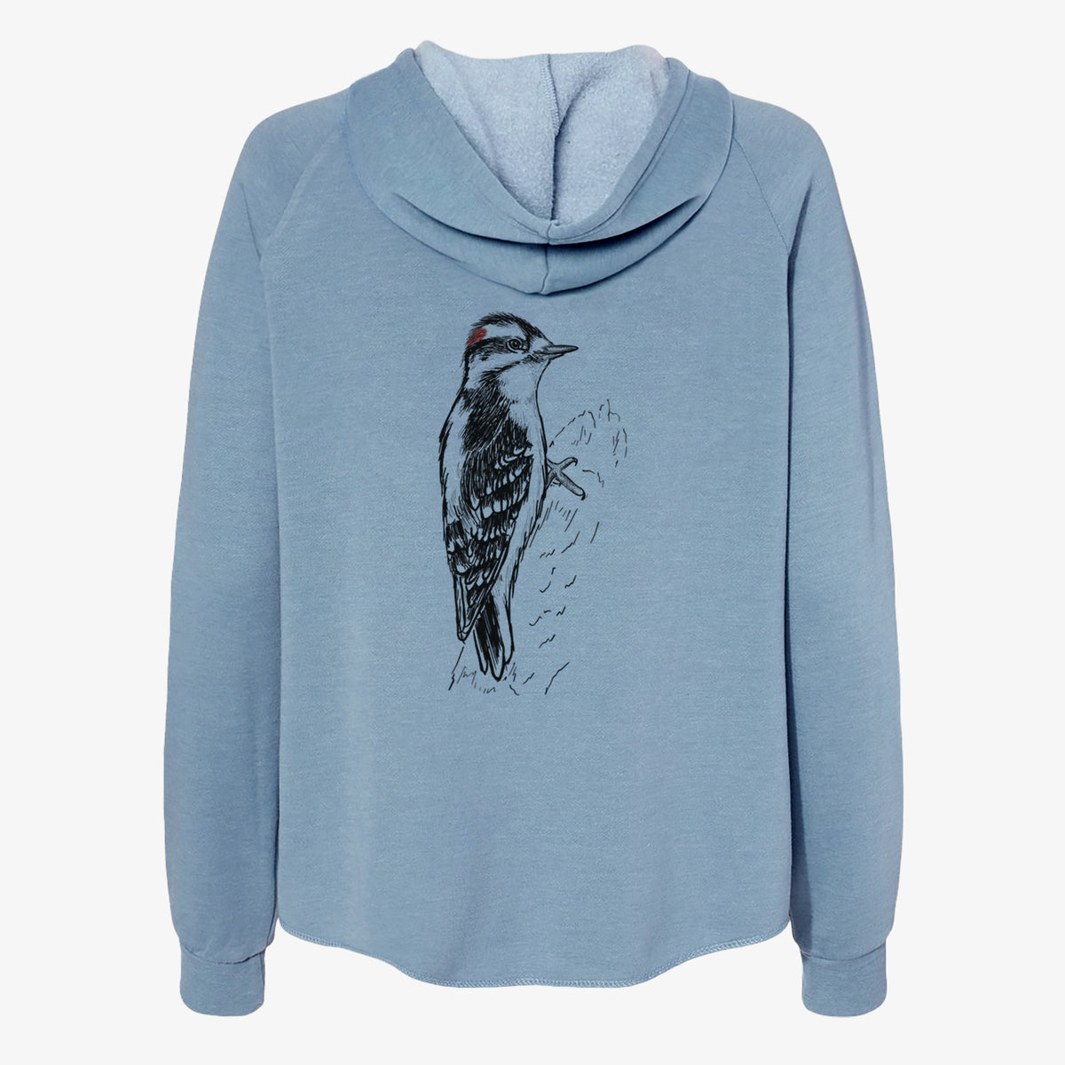 Misty blue women's Cali Wave zip-up sweatshirt laid flat, printed with a detailed black ink illustration of a downy woodpecker clinging to a tree trunk.