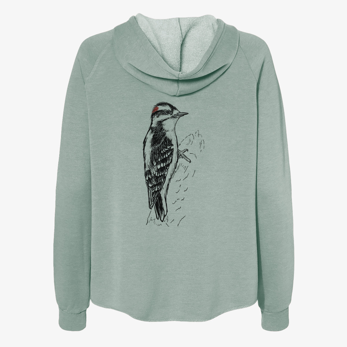 Sage green women's Cali Wave zip-up sweatshirt laid flat, printed with a detailed black ink illustration of a downy woodpecker clinging to a tree trunk.