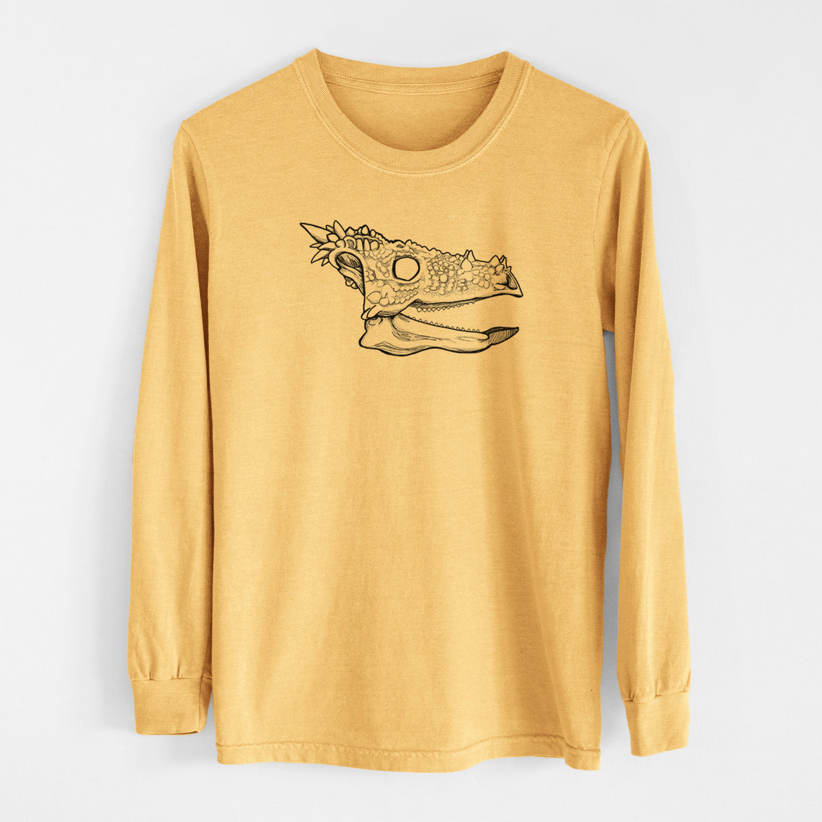 Golden wheat yellow Comfort Colors long sleeve shirt laid flat, printed with a black ink illustration of a spiky Dracorex dinosaur skull.