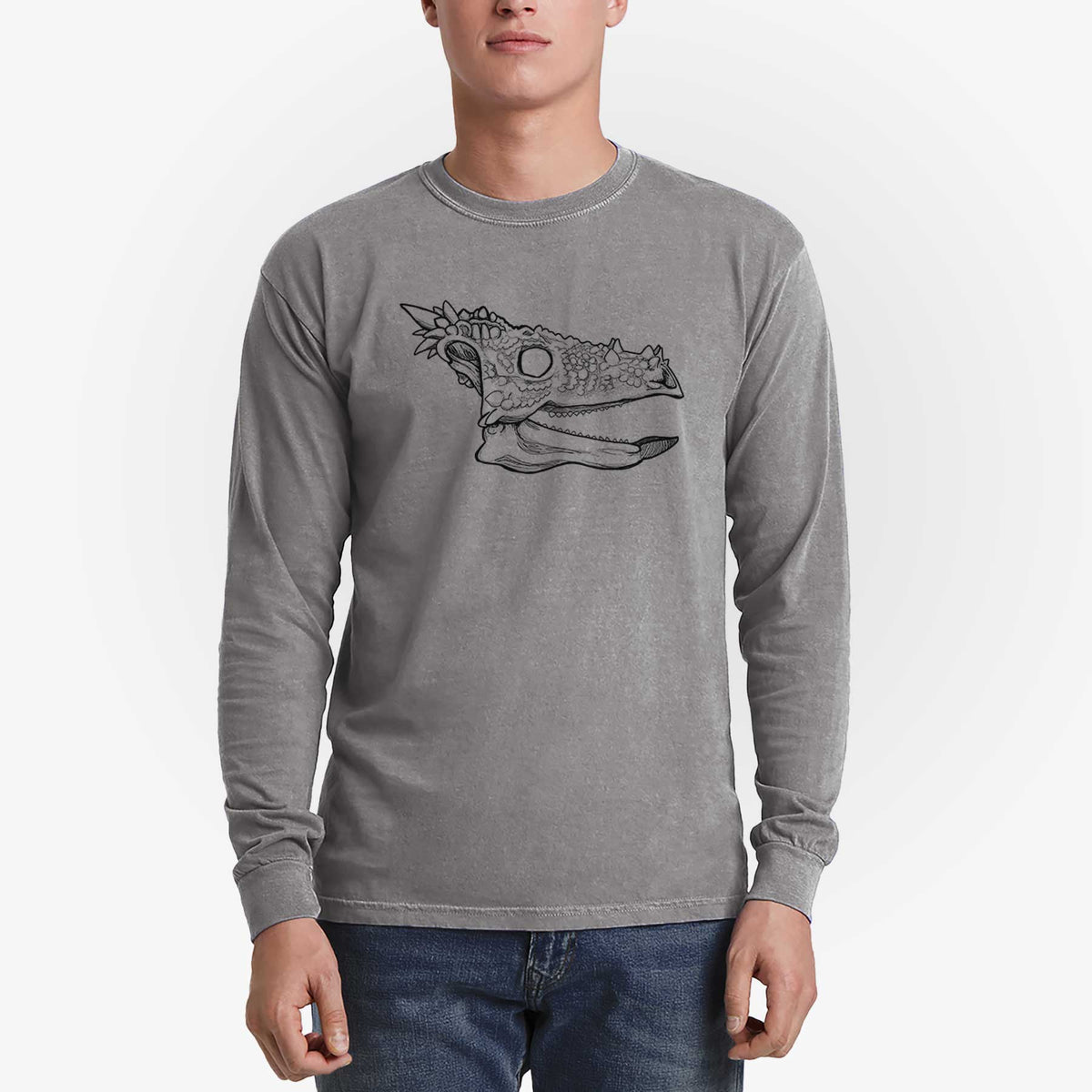 Man wearing a grey Comfort Colors long sleeve shirt printed with a black ink illustration of a spiky Dracorex dinosaur skull.
