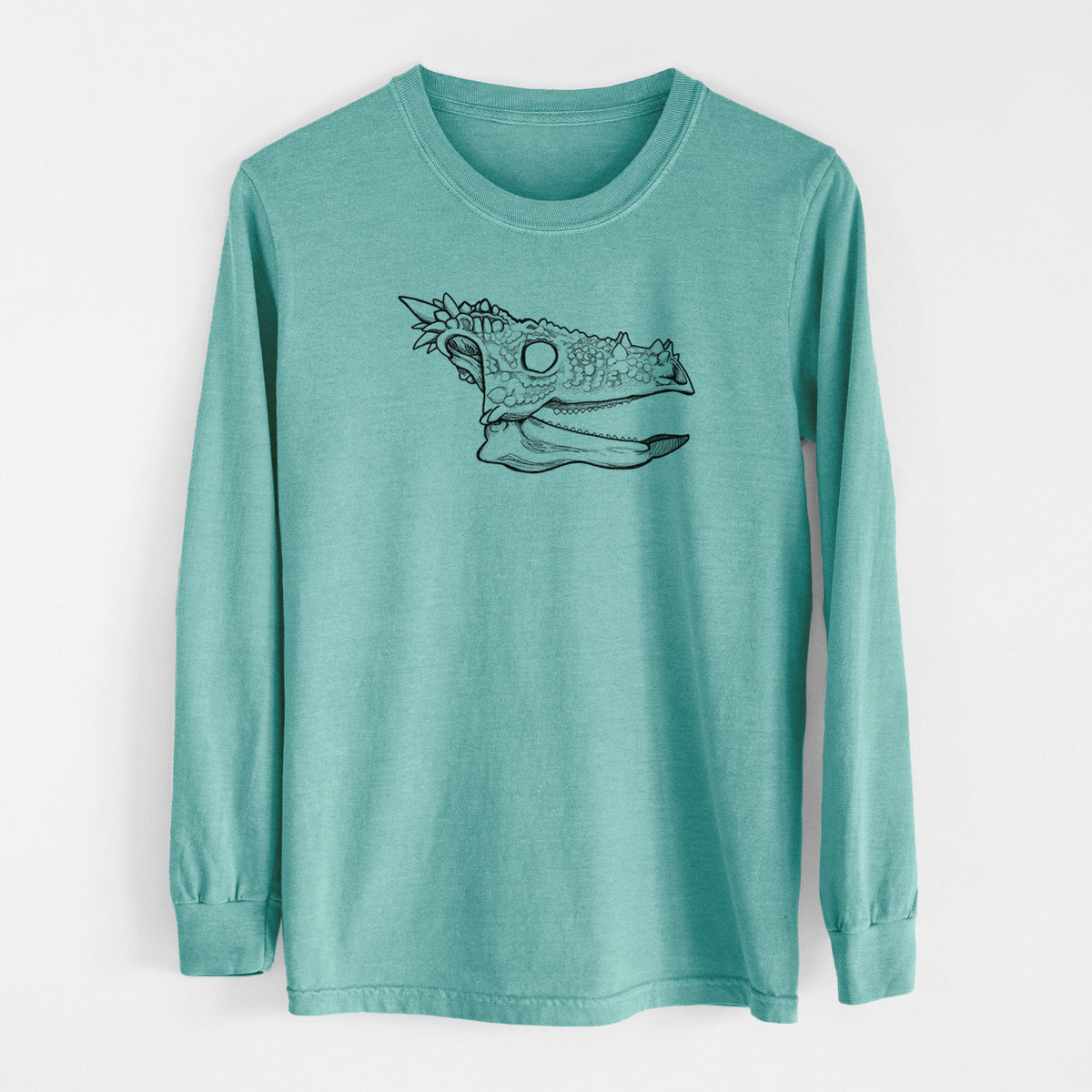 Reef green Comfort Colors long sleeve shirt laid flat, printed with a black ink illustration of a spiky Dracorex dinosaur skull.