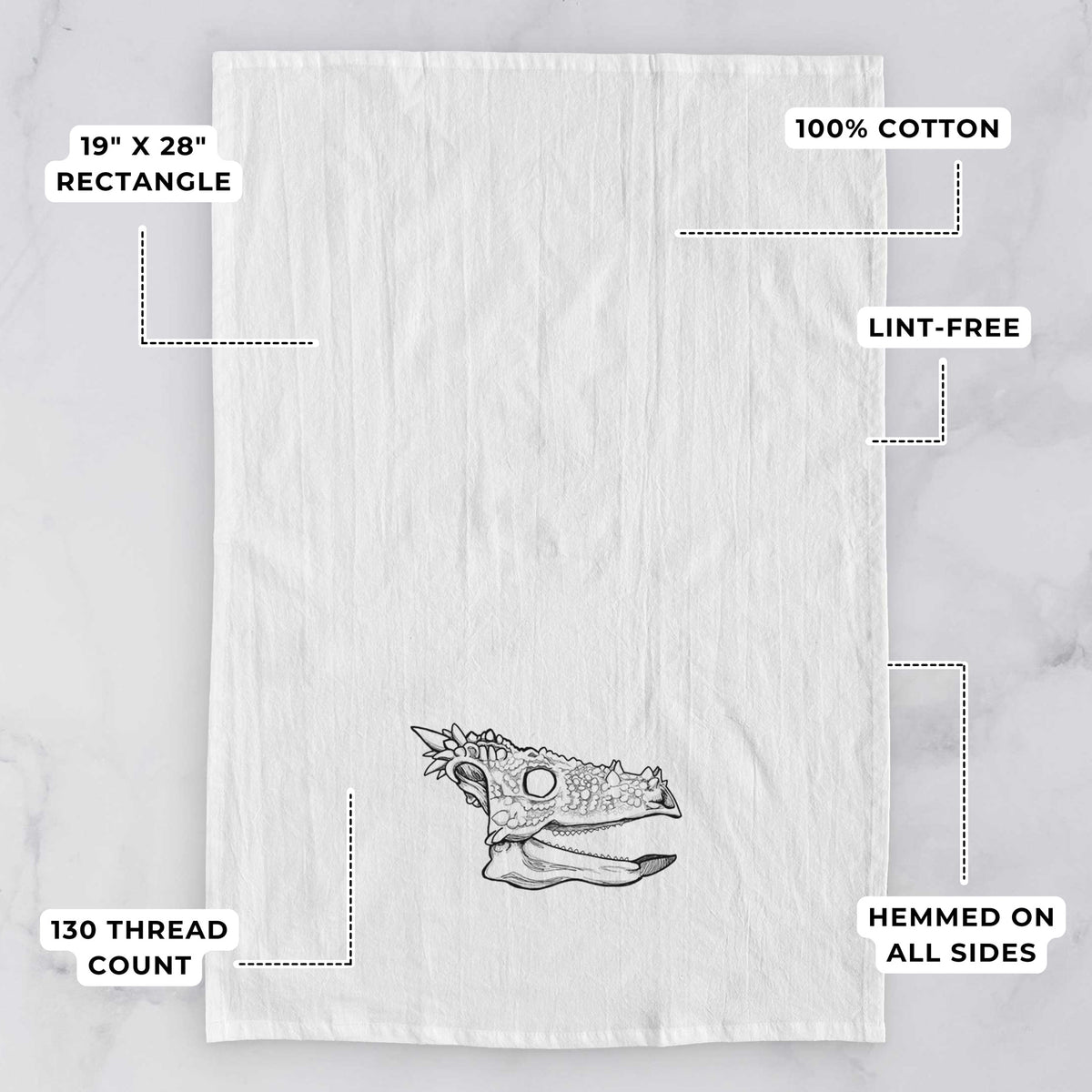 White tea towel printed with a black ink illustration of a spiky Dracorex dinosaur skull, with feature labels: 19 by 28 inch rectangle, 100% cotton, lint-free, 130 thread count, hemmed on all sides.