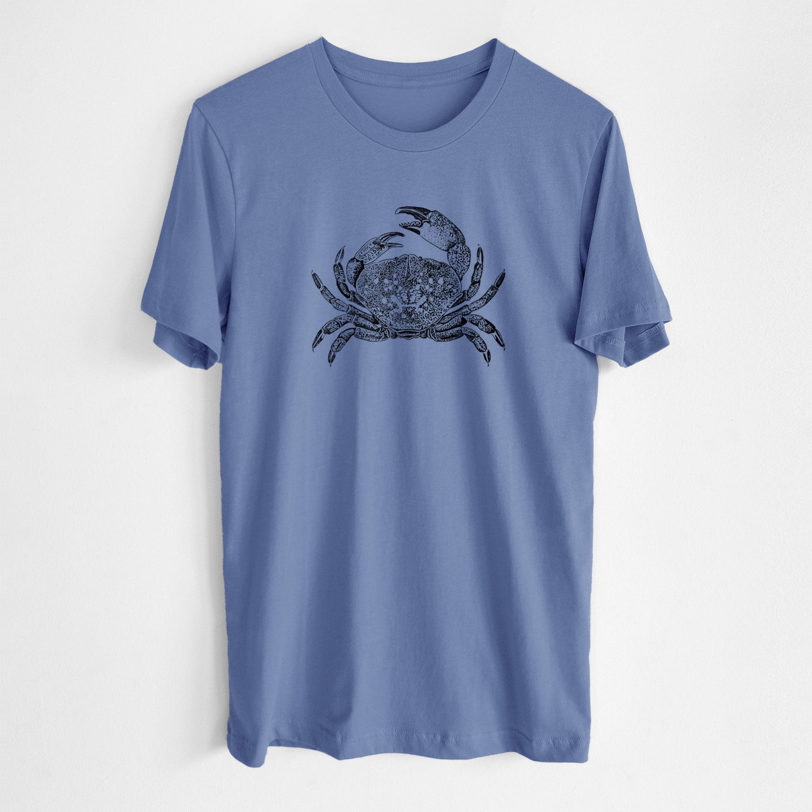 Blue bell lightweight cotton t-shirt laid flat, printed with a detailed black ink illustration of a Dungeness crab with claws raised, seen from above.
