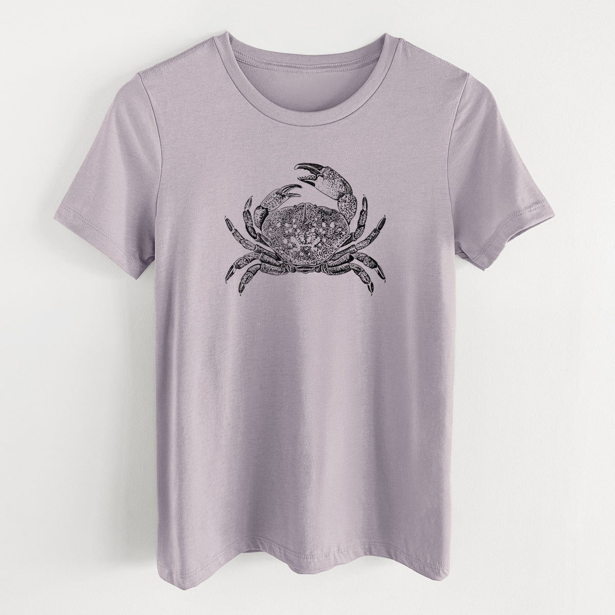 Light violet women's relaxed fit cotton t-shirt laid flat, printed with a detailed black ink illustration of a Dungeness crab with claws raised, seen from above.