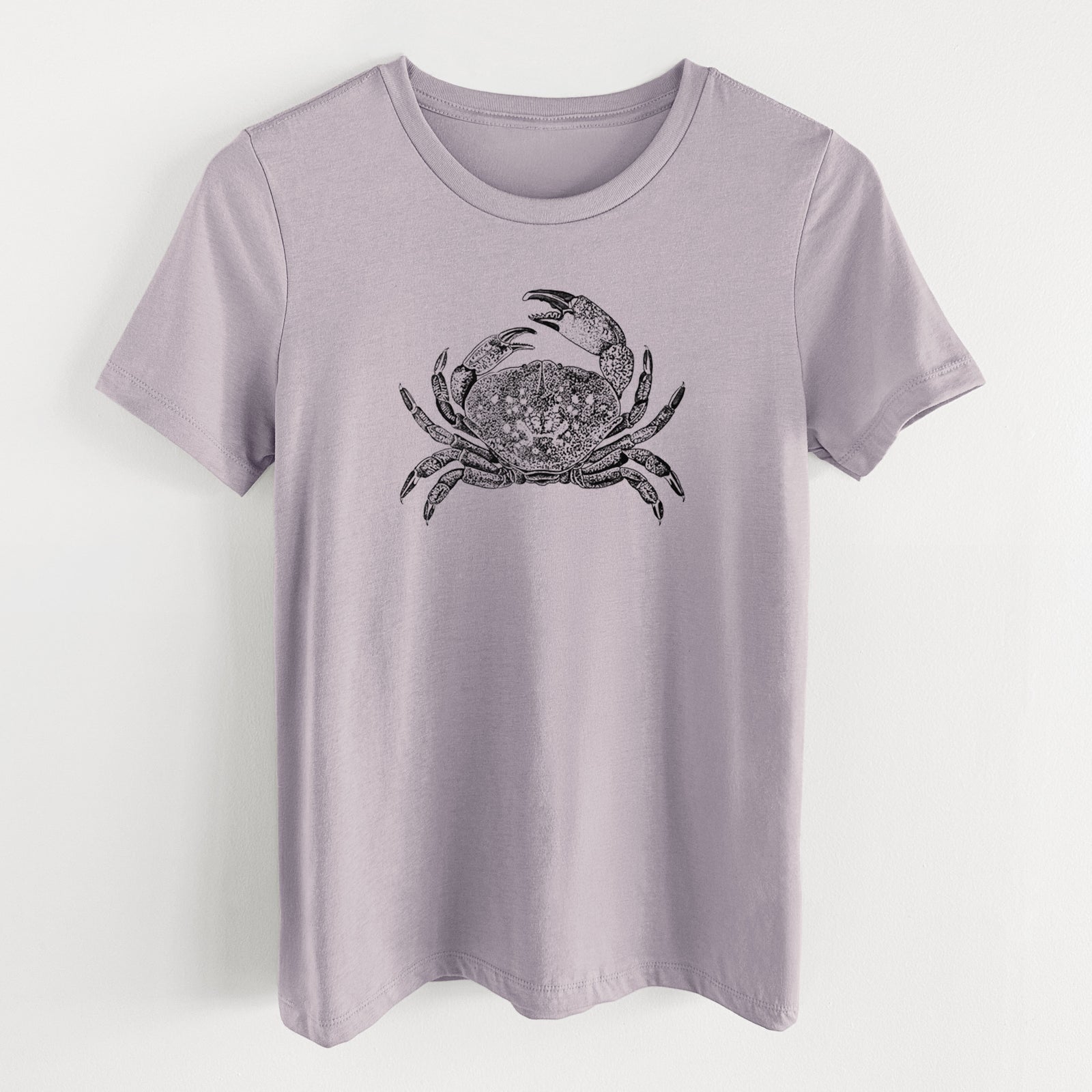 Light violet women's relaxed fit cotton t-shirt laid flat, printed with a detailed black ink illustration of a Dungeness crab with claws raised, seen from above.