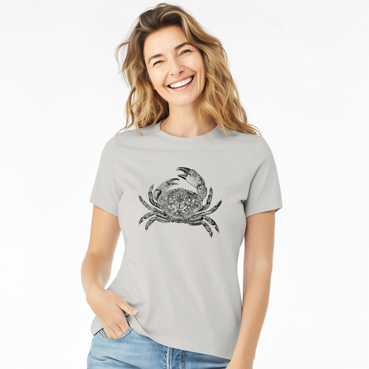 Woman wearing a lunar grey women's relaxed fit cotton t-shirt printed with a detailed black ink illustration of a Dungeness crab with claws raised, seen from above.