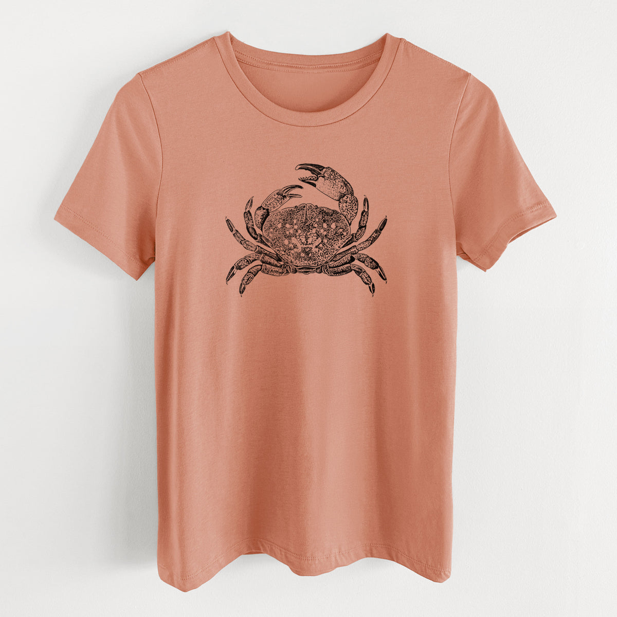 Terracotta orange women's relaxed fit cotton t-shirt laid flat, printed with a detailed black ink illustration of a Dungeness crab with claws raised, seen from above.