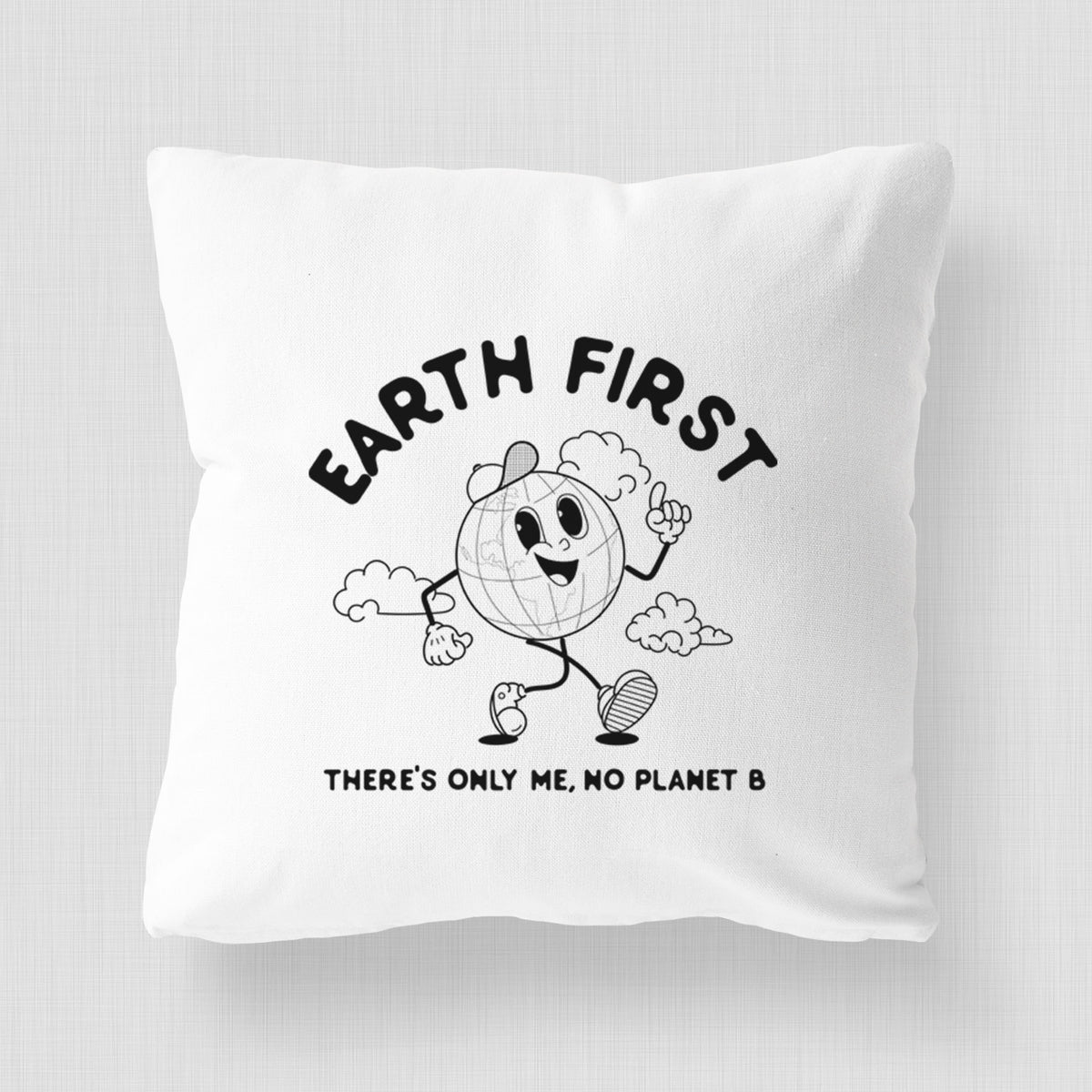 White pillow cover printed with a cheerful cartoon Earth running, with the words Earth First and There's Only Me, No Planet B.