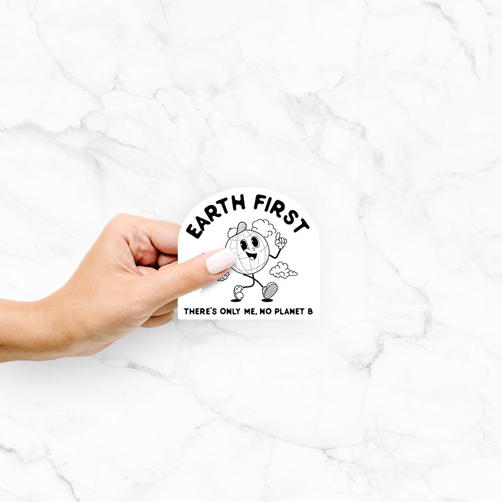 Hand holding a 4 inch vinyl decal of a cheerful cartoon Earth running, with the words Earth First and There's Only Me, No Planet B.