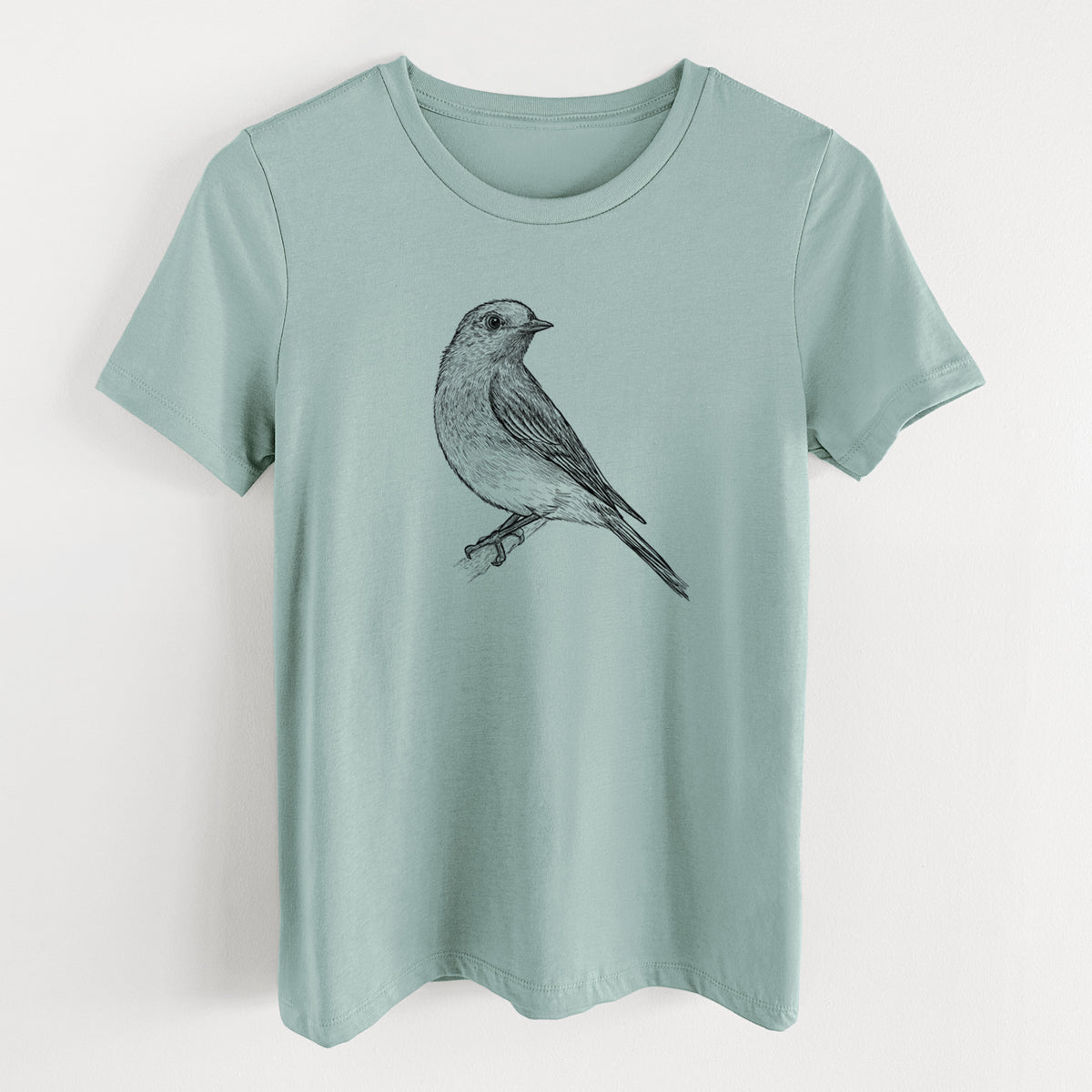 Dusty blue women's relaxed fit cotton t-shirt laid flat, printed with a detailed black ink sketch of an eastern bluebird perched on a branch.