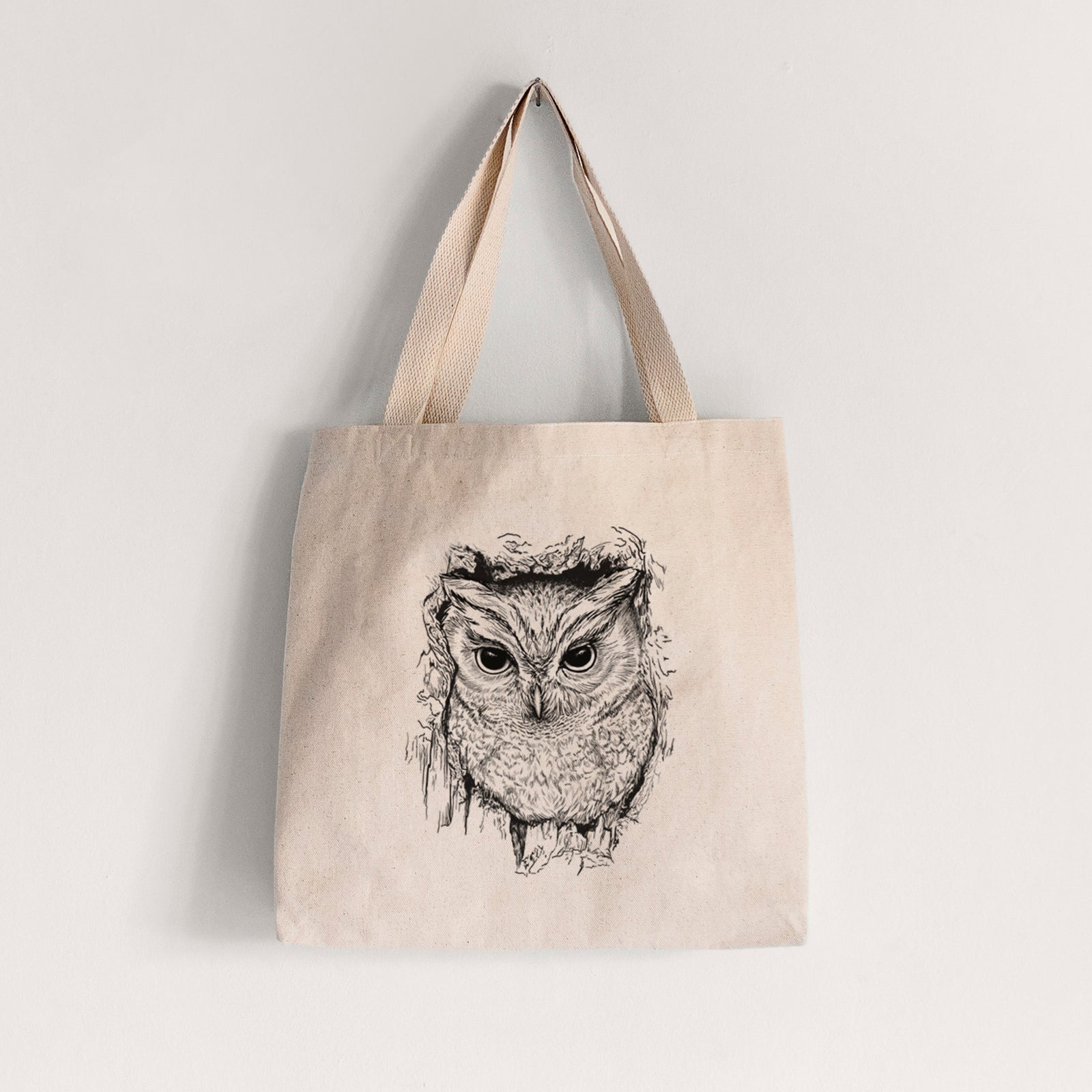 Natural canvas tote bag printed with a detailed black ink portrait of an eastern screech owl with its ear tufts raised.