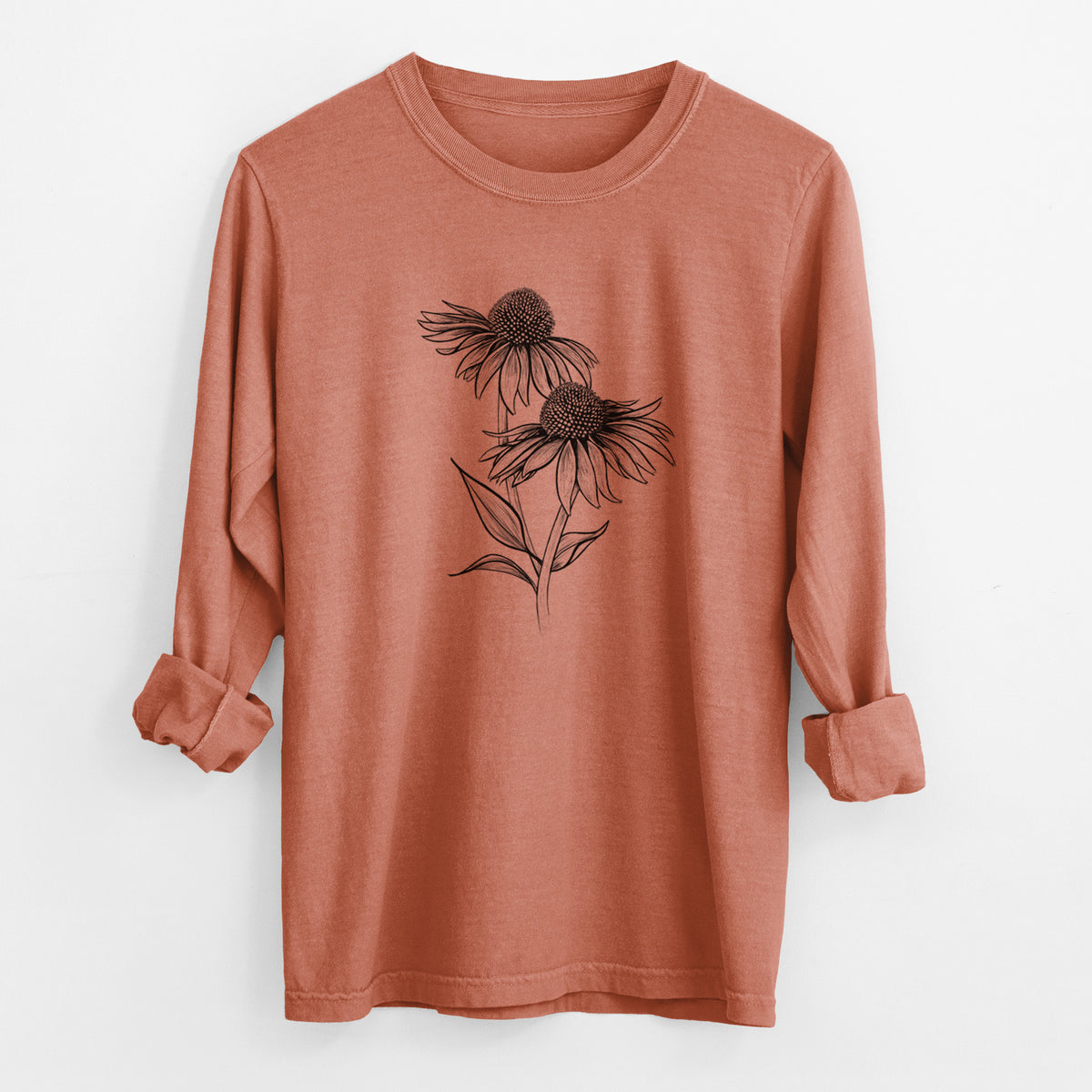 Yam burnt orange Comfort Colors long sleeve shirt laid flat with the cuffs rolled, printed with a black ink line drawing of two coneflowers on tall stems.