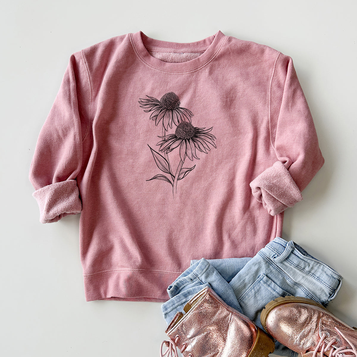 Youth crewneck sweatshirt printed with a black ink line drawing of two coneflowers on tall stems, styled flat with jeans and boots.