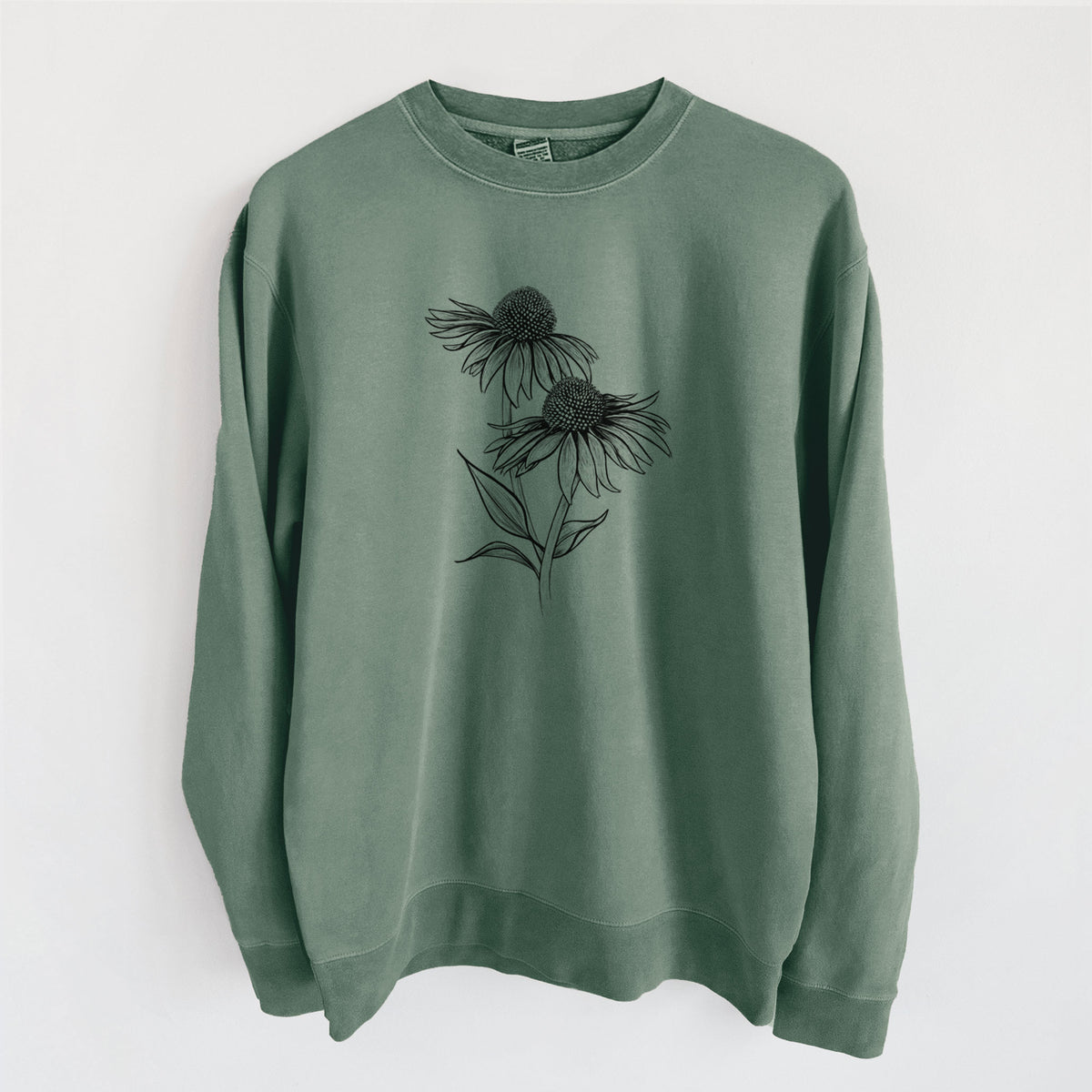 Alpine green pigment dyed crewneck sweatshirt laid flat, printed with a black ink line drawing of two coneflowers on tall stems.