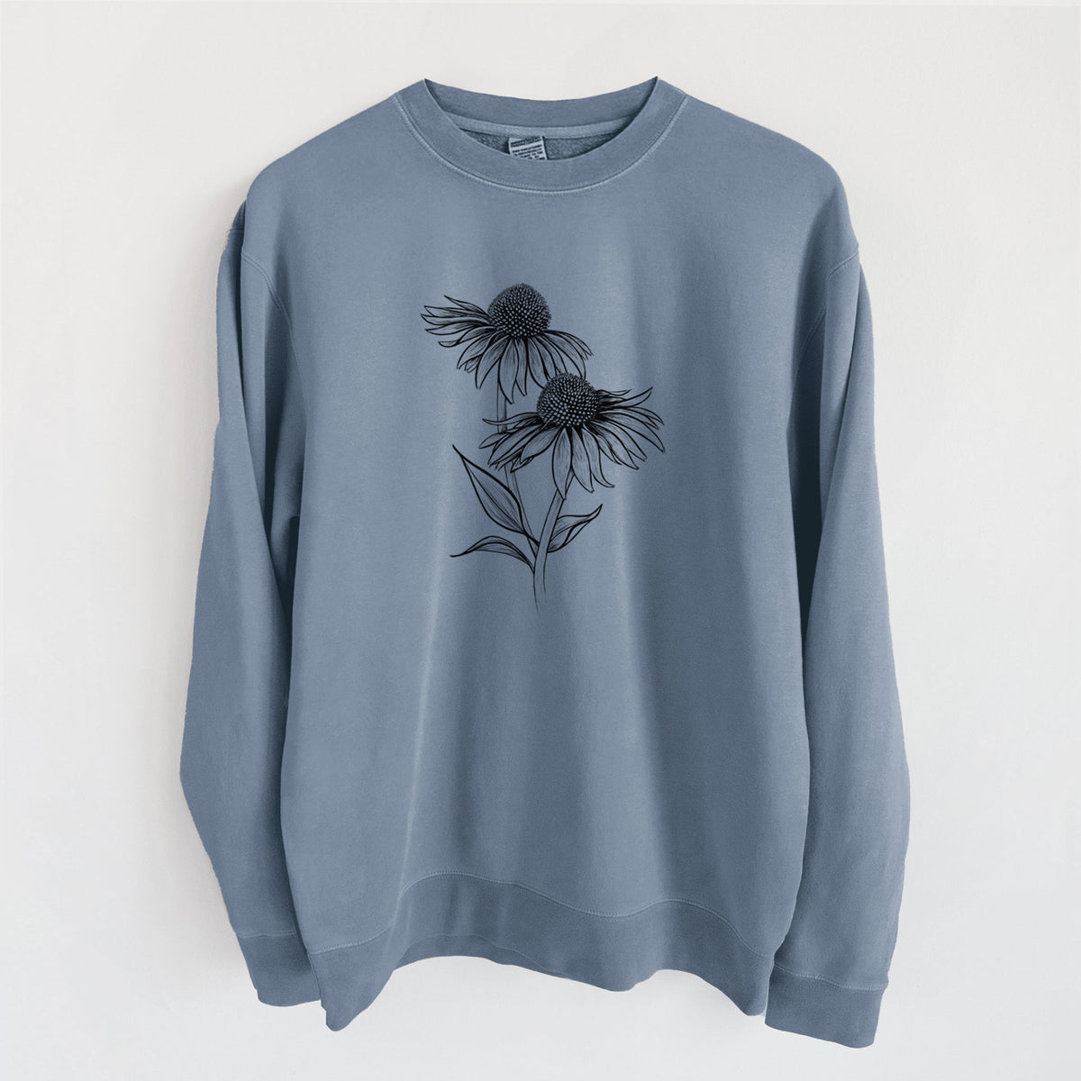 Slate blue pigment dyed crewneck sweatshirt laid flat, printed with a black ink line drawing of two coneflowers on tall stems.