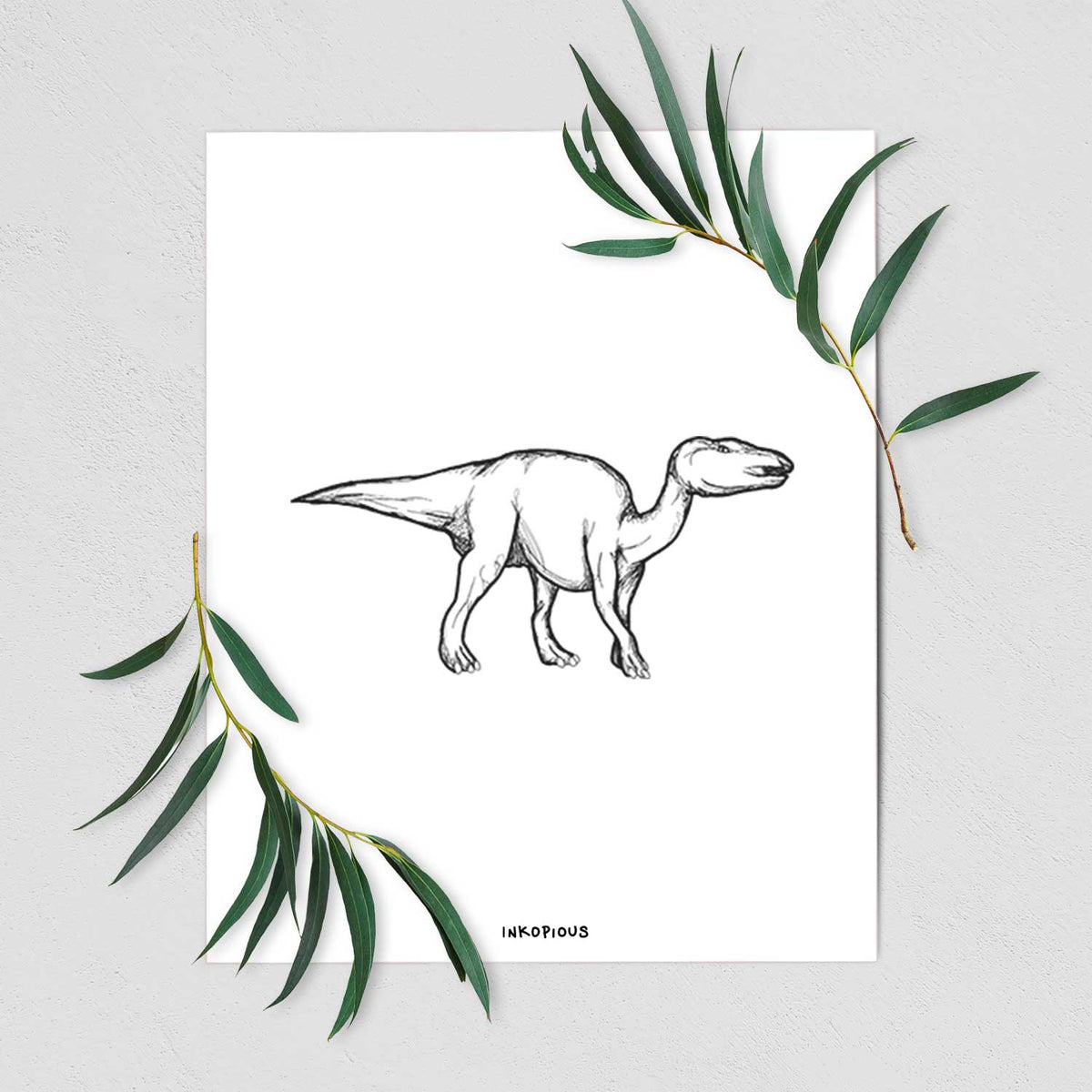 Art print of a black ink illustration of an Edmontosaurus walking, shown with eucalyptus leaves.