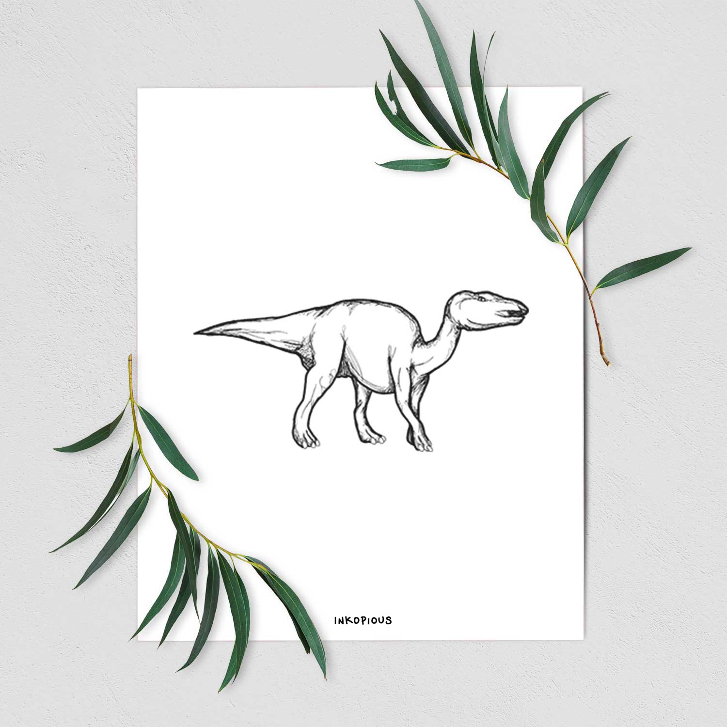 Art print of a black ink illustration of an Edmontosaurus walking, shown with eucalyptus leaves.