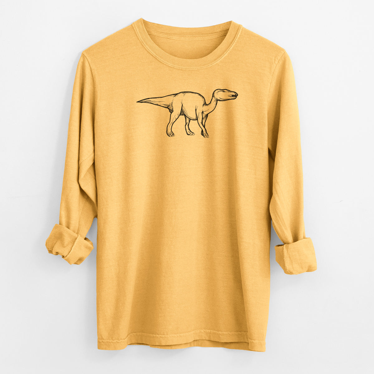 Golden wheat yellow Comfort Colors long sleeve shirt laid flat with the cuffs rolled, printed with a black ink illustration of an Edmontosaurus walking.