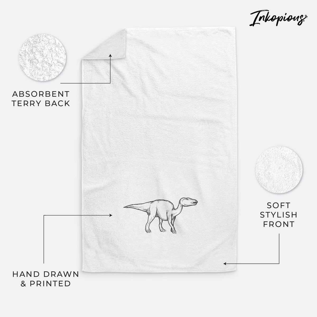 White hand towel printed with a black ink illustration of an Edmontosaurus walking.