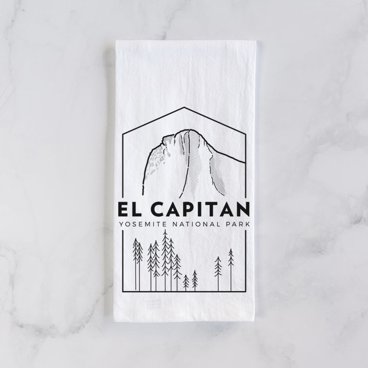 White cotton tea towel laid flat on marble, printed with a black line art badge of El Capitan rising above a pine forest, with the words El Capitan, Yosemite National Park.
