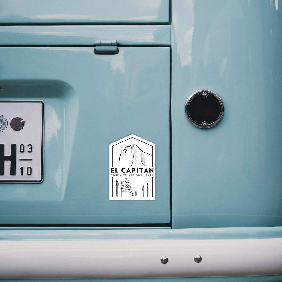 4 inch vinyl decal of a black line art badge of El Capitan rising above a pine forest, with the words El Capitan, Yosemite National Park on the back of a van.