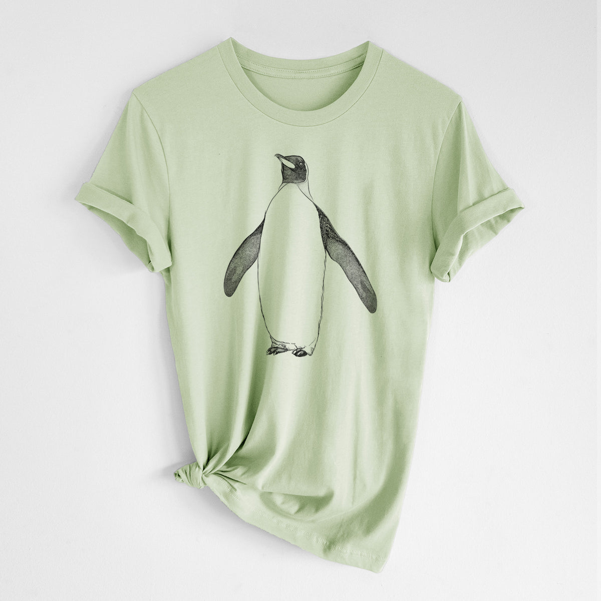 Spring green lightweight cotton t-shirt laid flat with the sleeves rolled, printed with a black ink illustration of an emperor penguin standing.