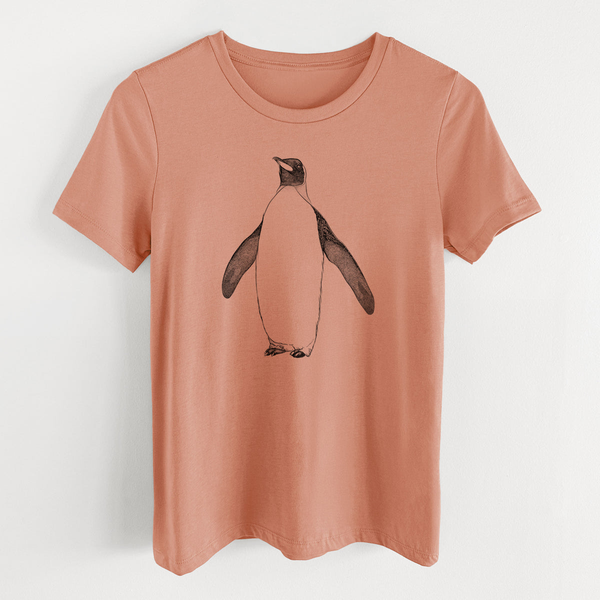 Terracotta orange women's relaxed fit cotton t-shirt laid flat, printed with a black ink illustration of an emperor penguin standing.