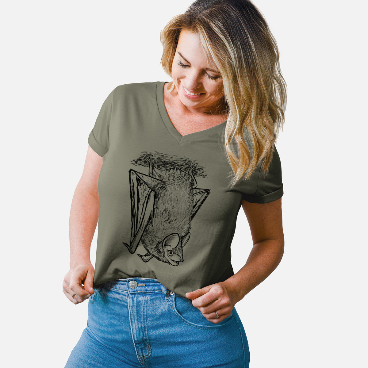 Woman wearing a military green women's relaxed fit cotton V-neck t-shirt printed with a detailed black ink illustration of a big brown bat hanging upside down.