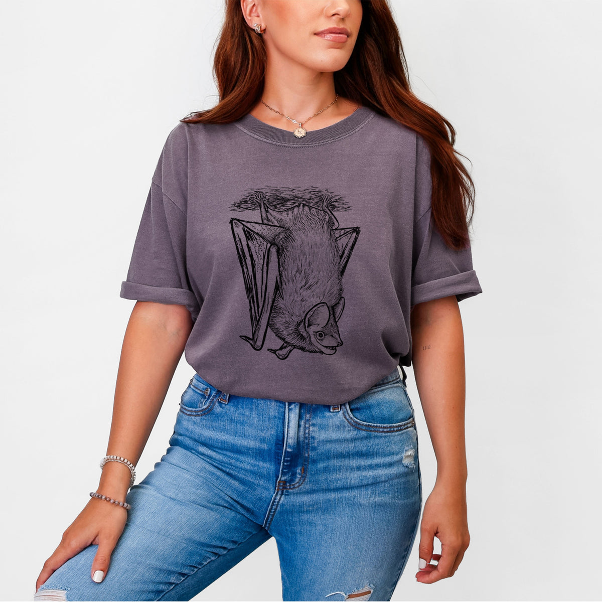 Woman wearing a Comfort Colors t-shirt printed with a detailed black ink illustration of a big brown bat hanging upside down.