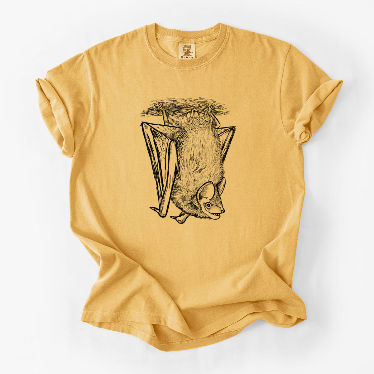 Golden wheat yellow Comfort Colors t-shirt laid flat, printed with a detailed black ink illustration of a big brown bat hanging upside down.