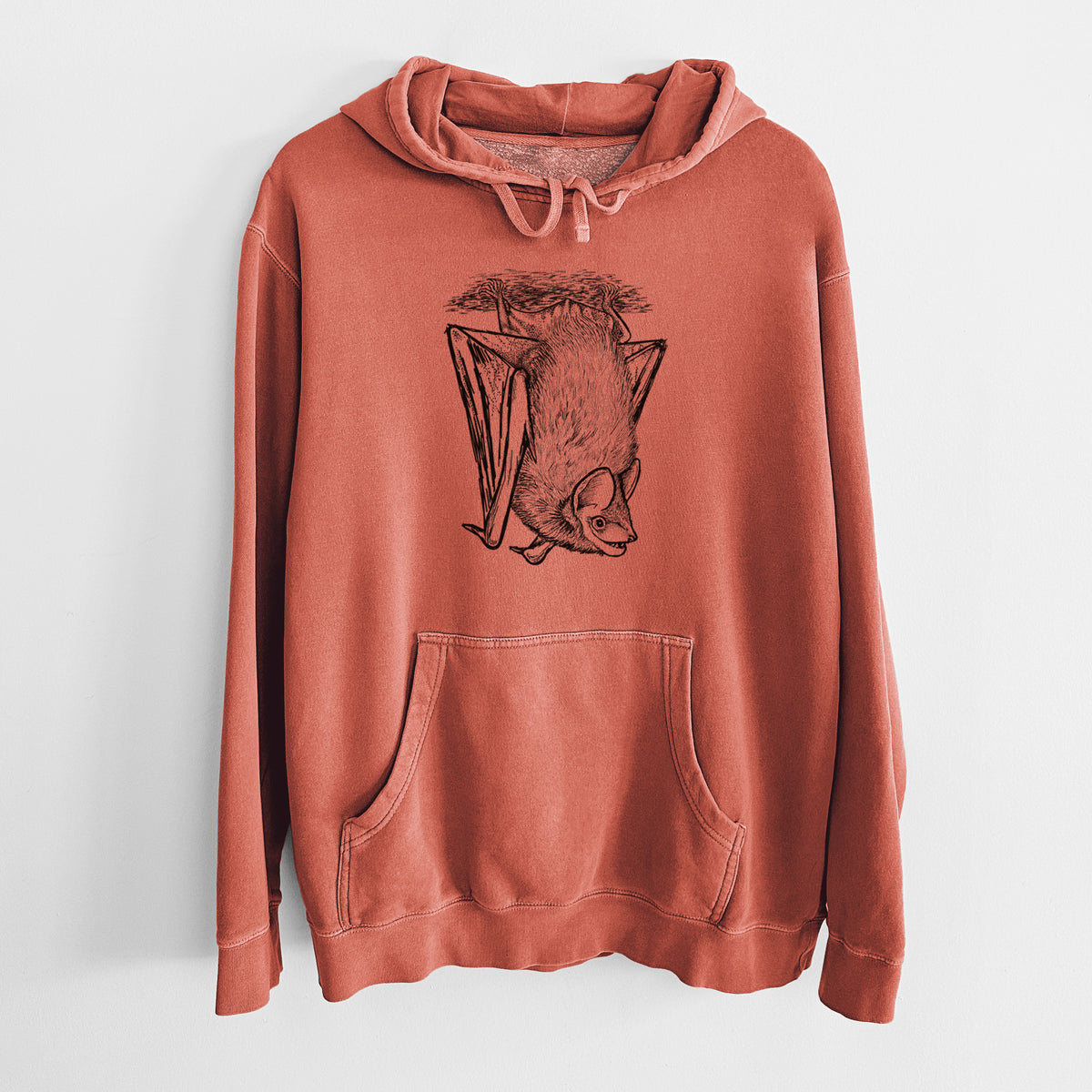 Amber orange pigment dyed hoodie laid flat, printed with a detailed black ink illustration of a big brown bat hanging upside down.