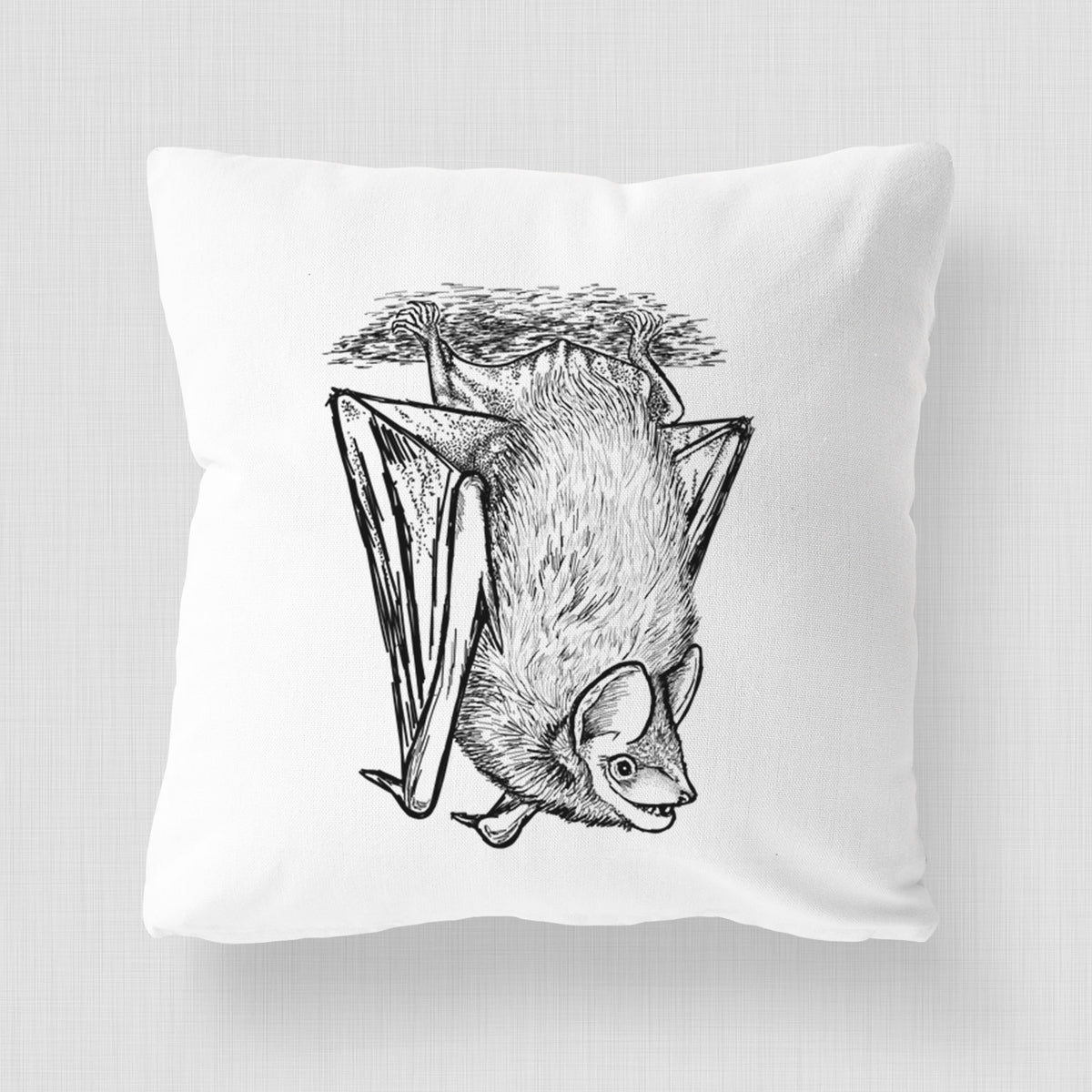 White pillow cover printed with a detailed black ink illustration of a big brown bat hanging upside down.