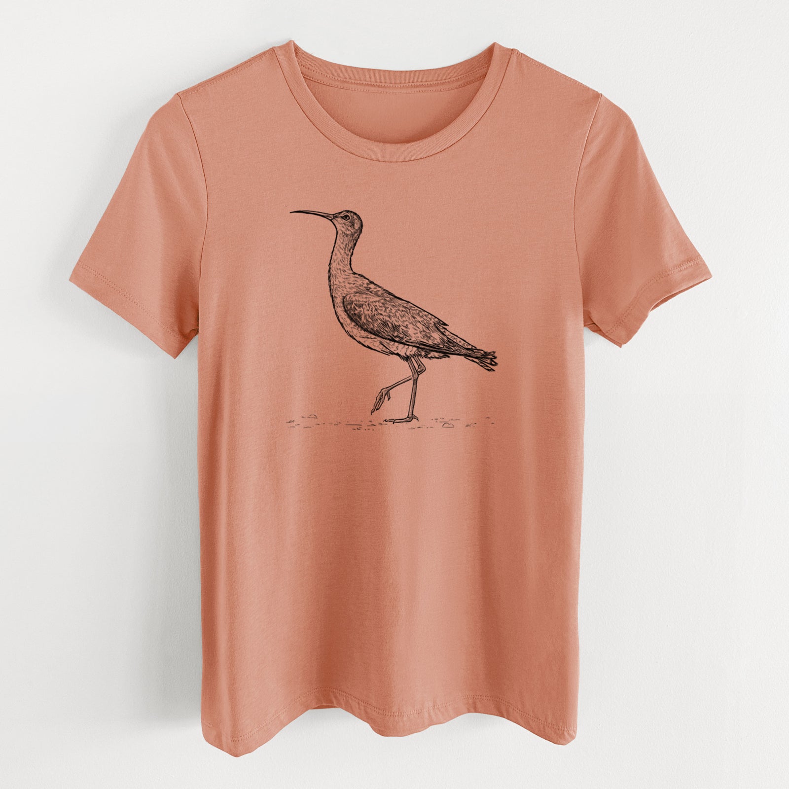 Terracotta orange women's relaxed fit cotton t-shirt laid flat, printed with a detailed black ink illustration of an Eskimo curlew with its long curved bill, walking.
