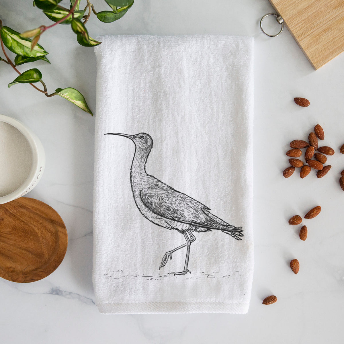 White hand towel printed with a detailed black ink illustration of an Eskimo curlew with its long curved bill, walking.
