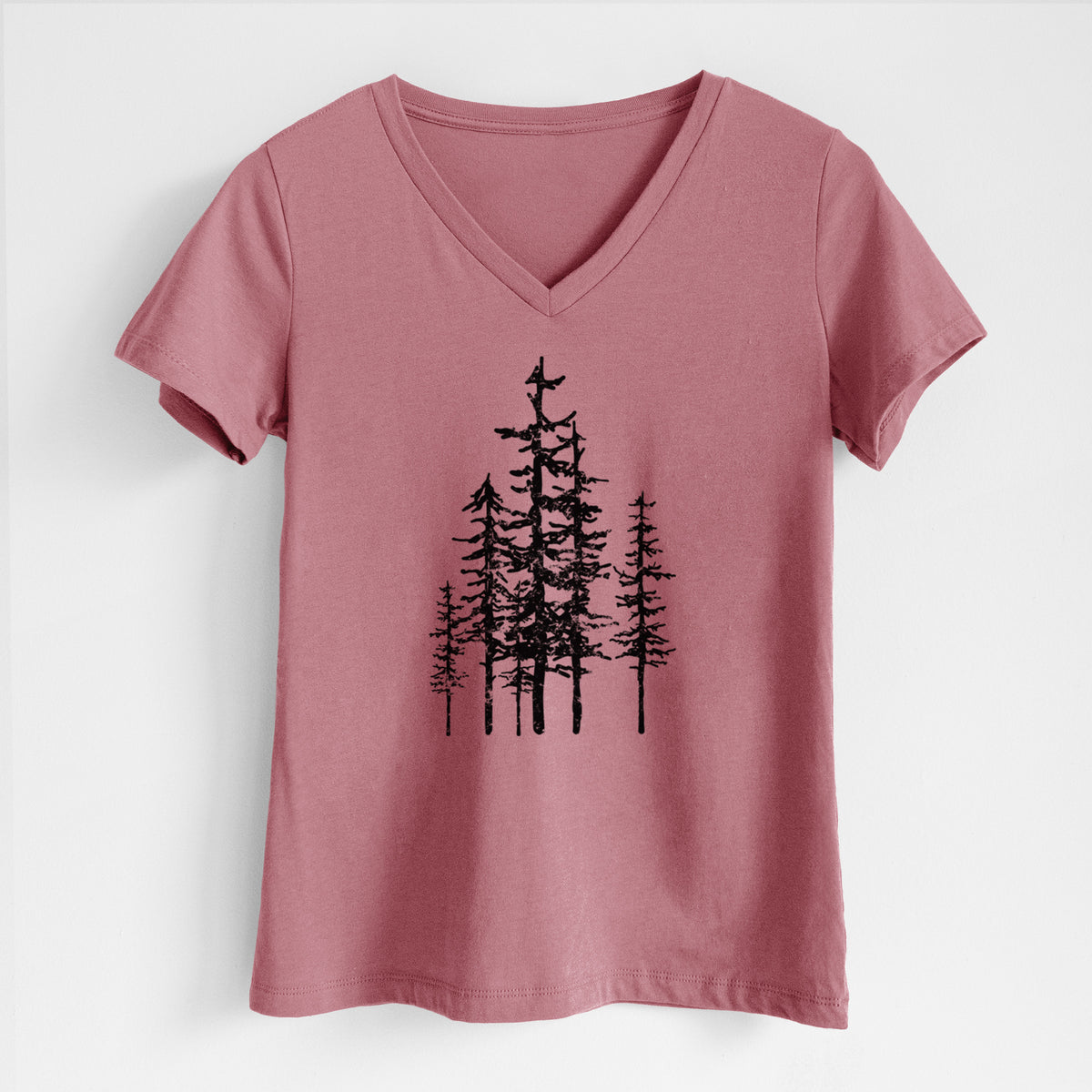 Mauve pink women's relaxed fit cotton V-neck t-shirt laid flat, printed with a black ink illustration of a cluster of evergreen trees of varying heights.
