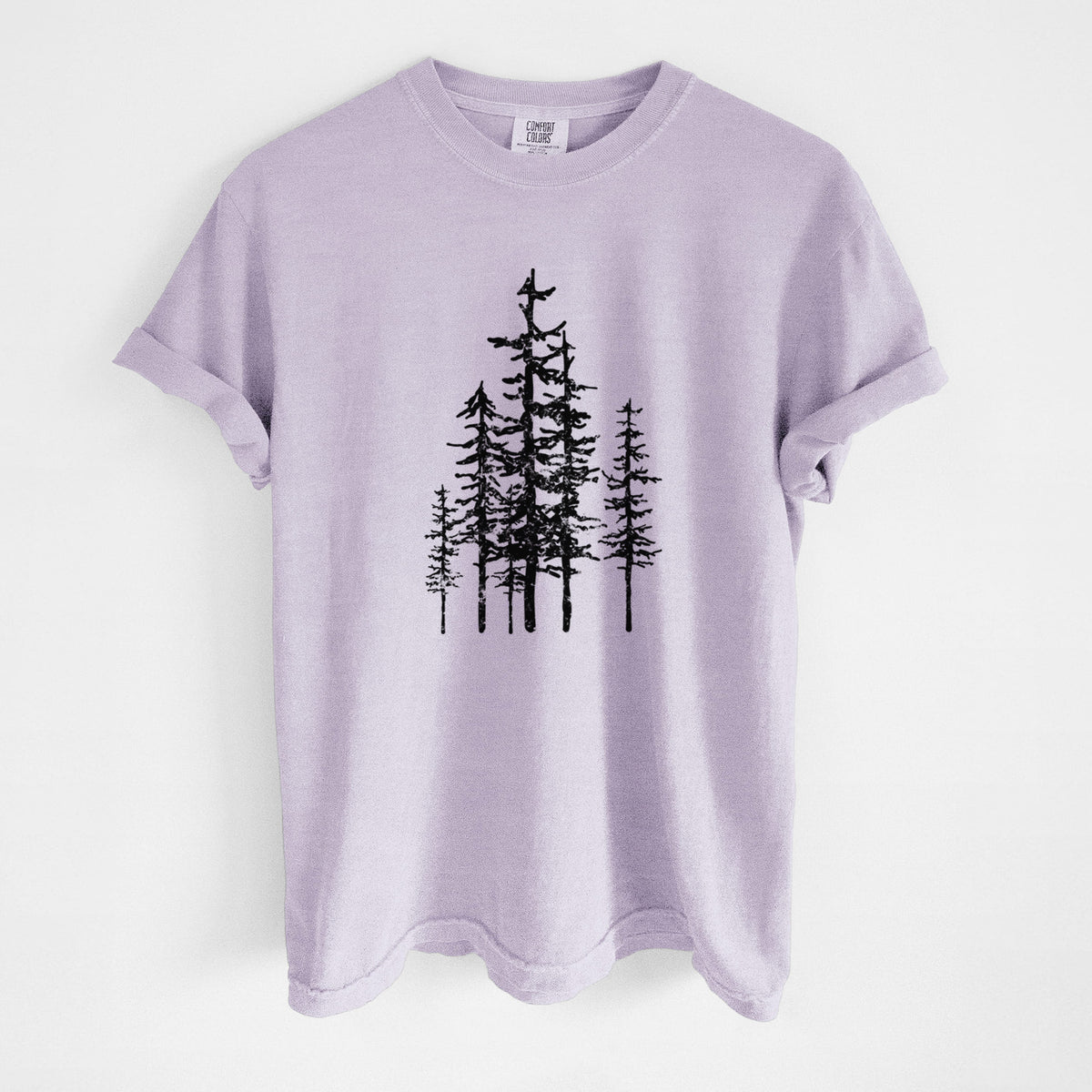 Orchid purple Comfort Colors t-shirt laid flat, printed with a black ink illustration of a cluster of evergreen trees of varying heights.