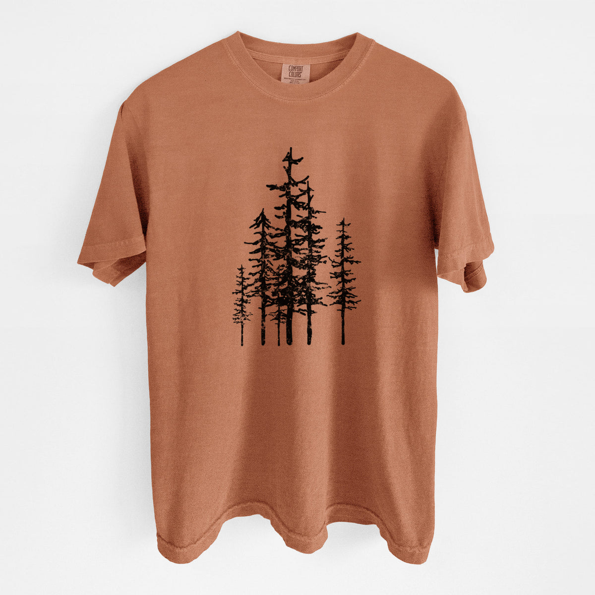 Yam burnt orange Comfort Colors t-shirt laid flat, printed with a black ink illustration of a cluster of evergreen trees of varying heights.