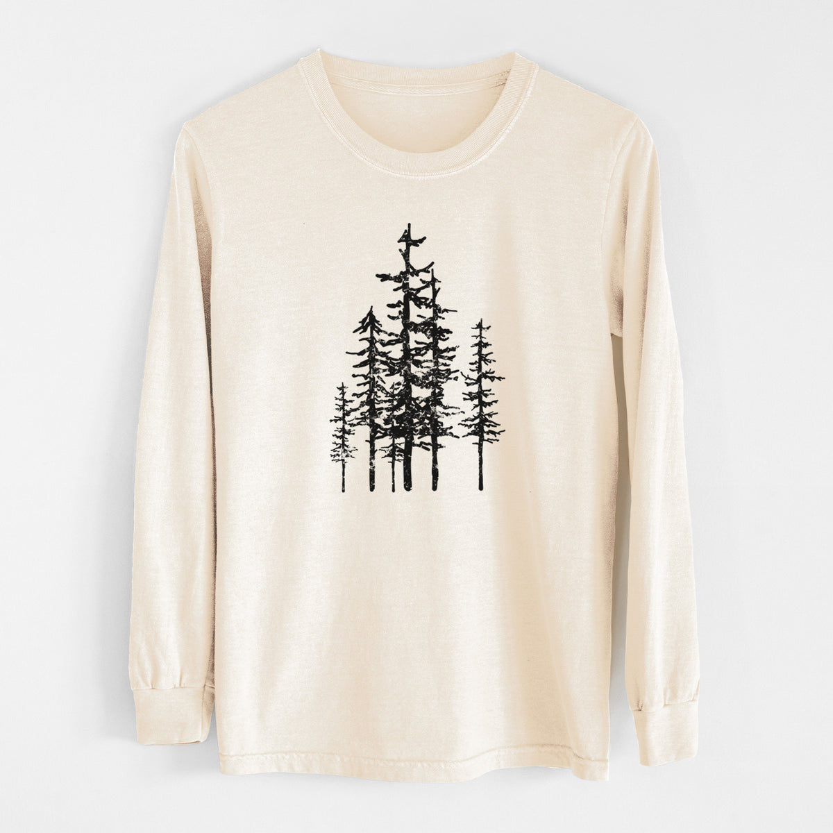 Ivory Comfort Colors long sleeve shirt laid flat, printed with a black ink illustration of a cluster of evergreen trees of varying heights.